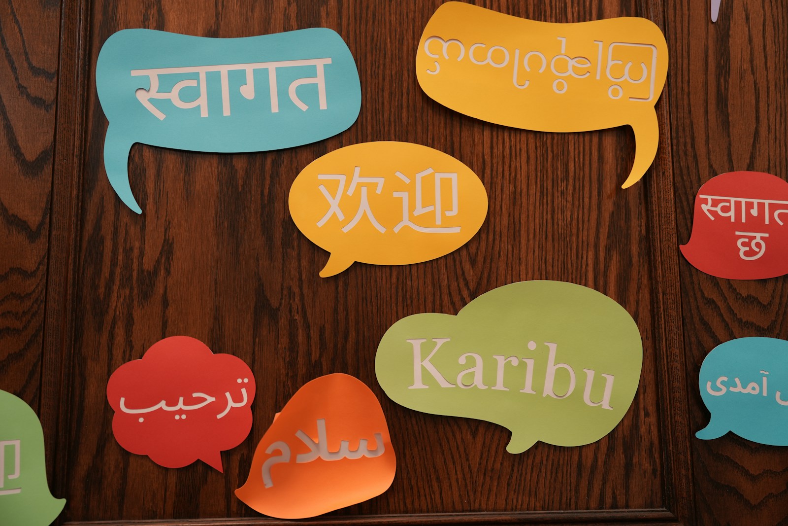 A group of colorful speech bubbles on a wooden wall