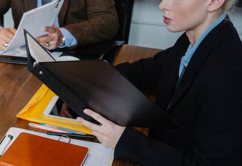 From above of multiracial lawyer and businessman talking about contract and business papers in office