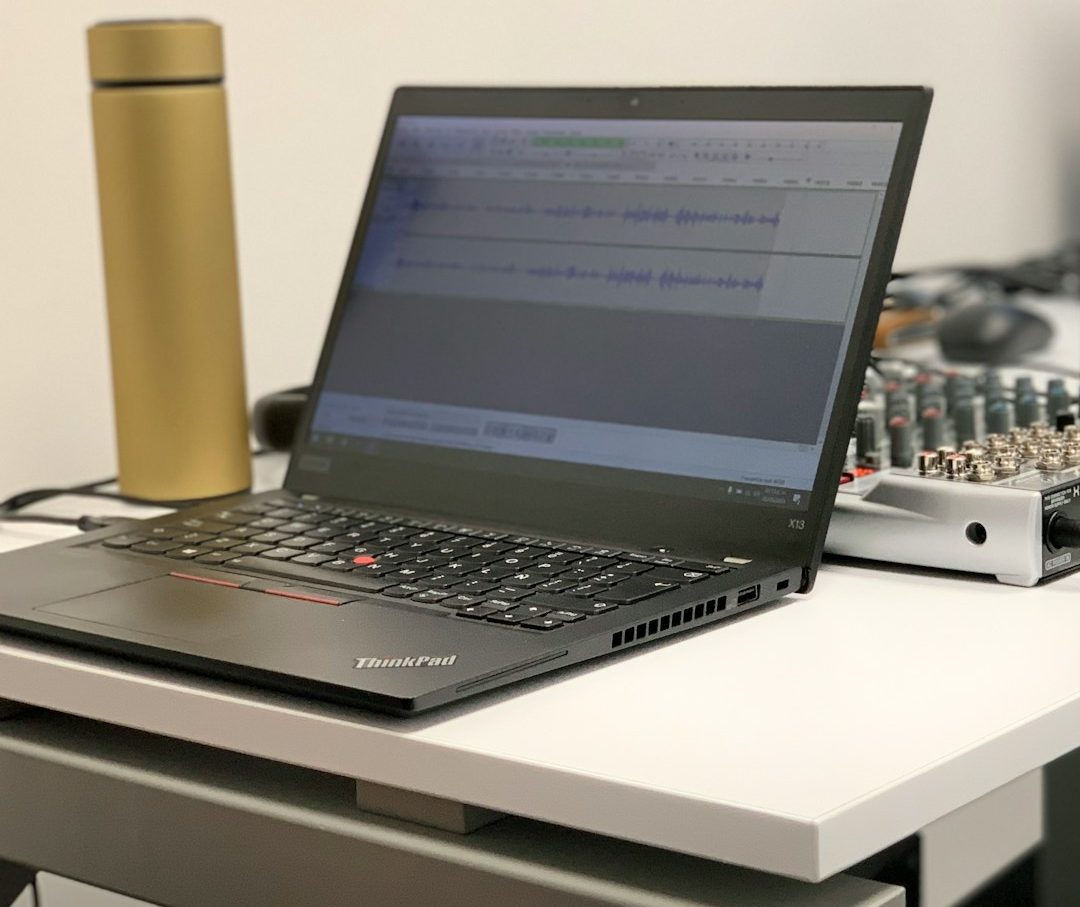 black laptop computer on white table