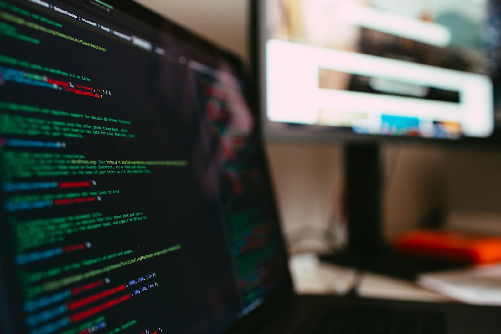 A detailed view of programming code displayed on a laptop screen, depicting a tech workspace.