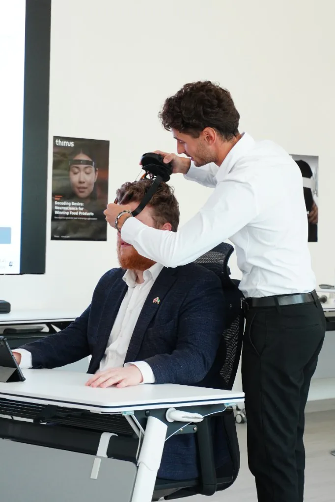 A Dev Centre House engineer fitting a T-box headset on a participant