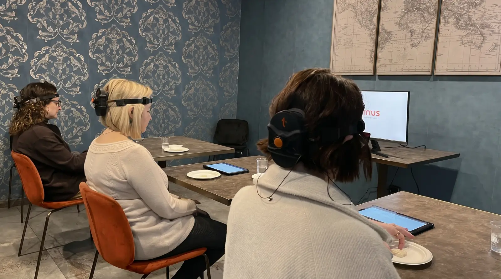 Researchers using T-box headsets with the cloud research software on a monitor